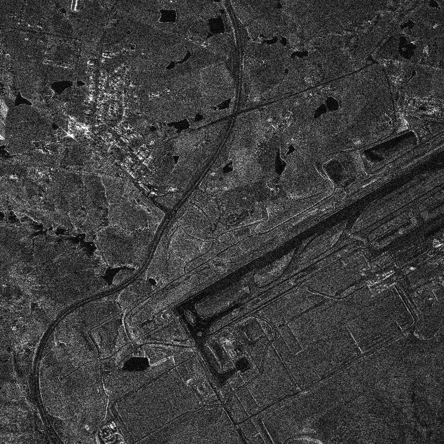Arden OpenSAR wide-area render of Western Sydney International Airport: a long runway running diagonally, taxiways, a terminal construction site, farmland and a town